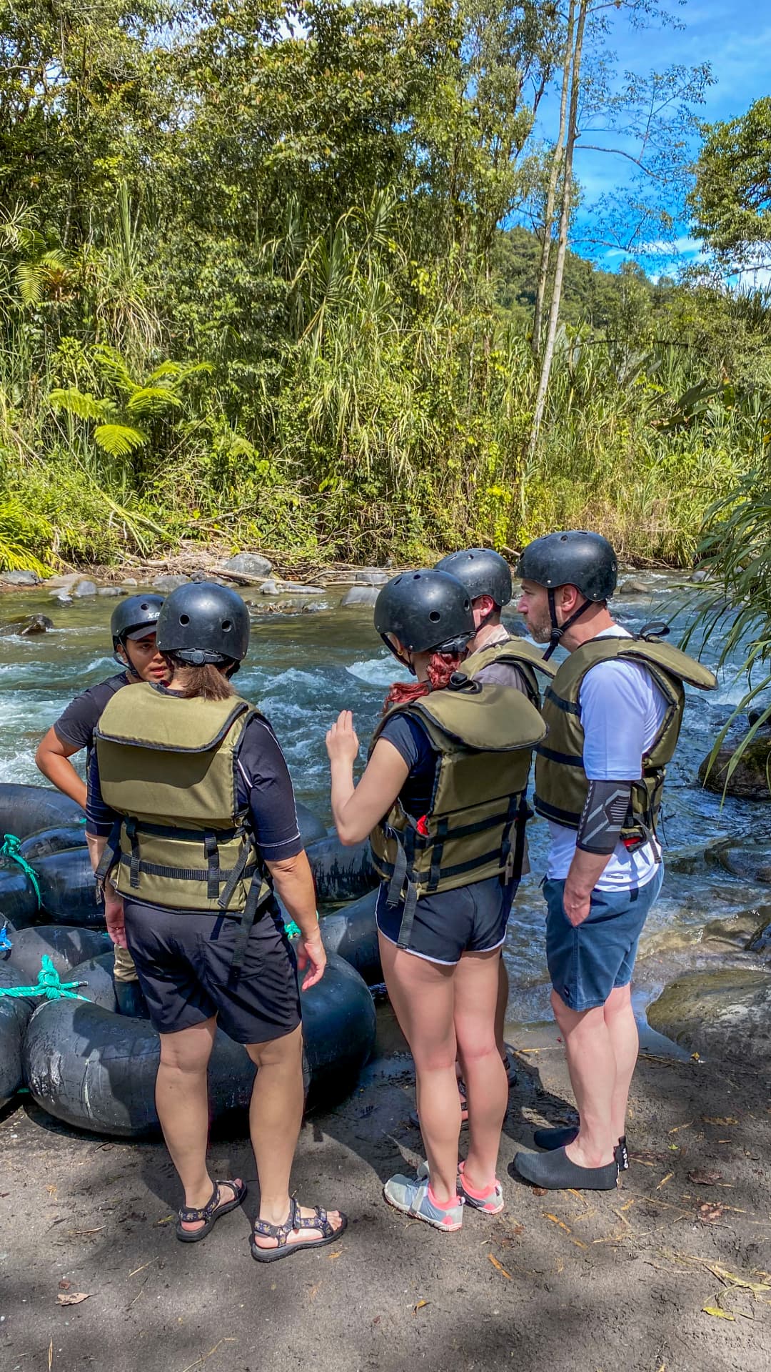 Tubing through green river scenery in Mindo